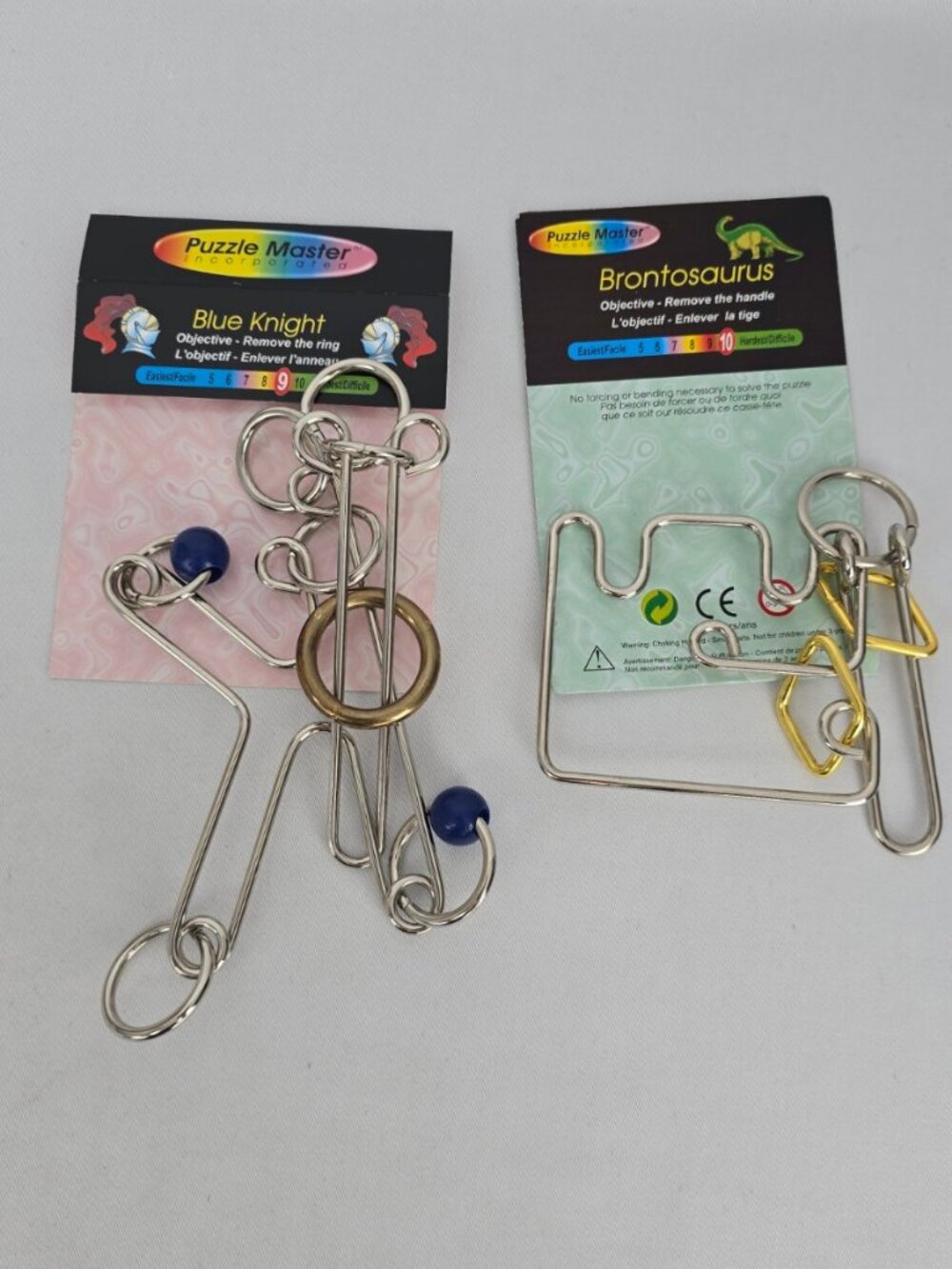 Puzzle Master Metal Wire Brain Teaser Puzzles — Blue Knight & Brontosaurus, Set
